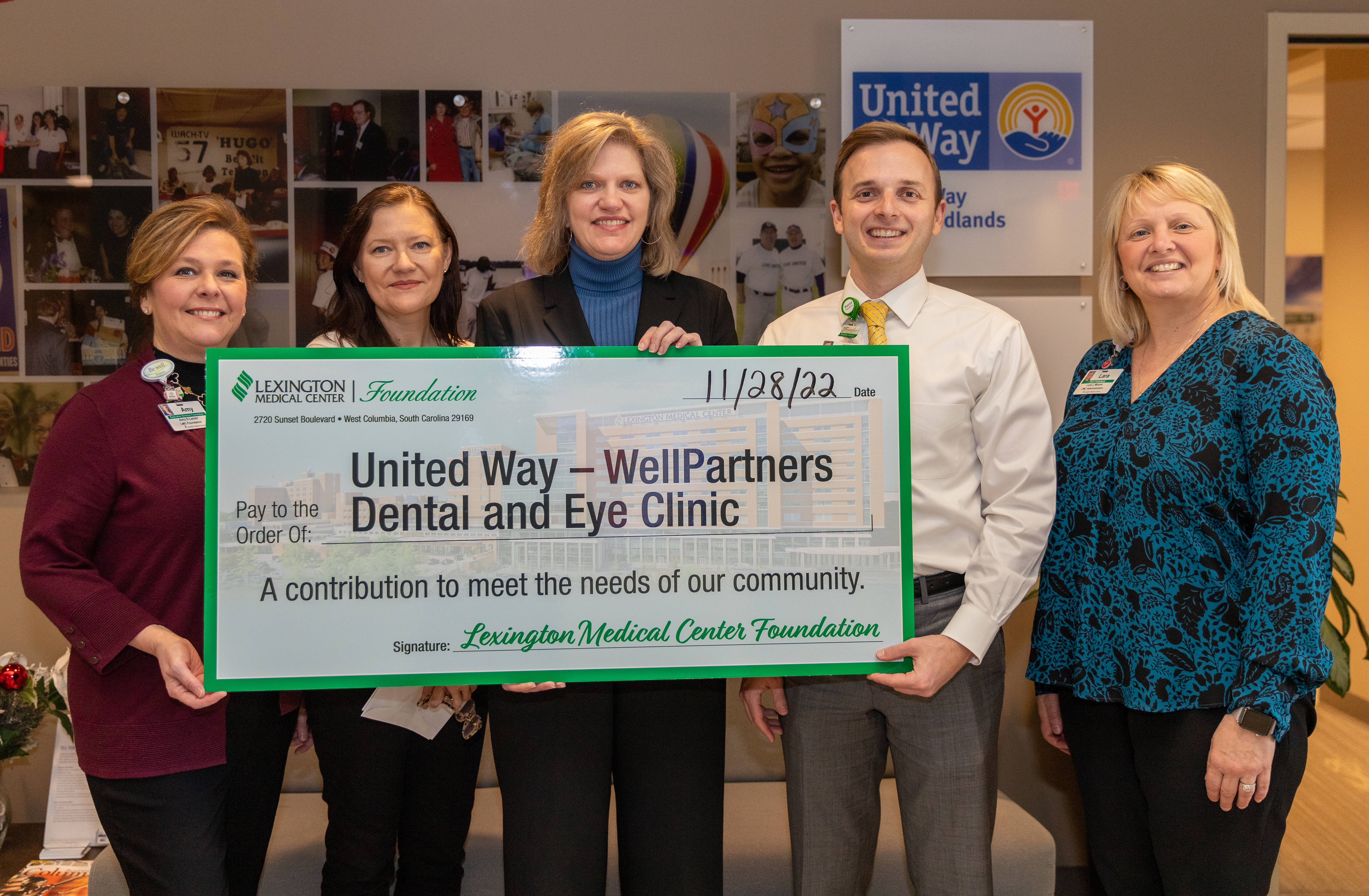 LMC presents check to UWM WellPartners Dental & Eye Clinic