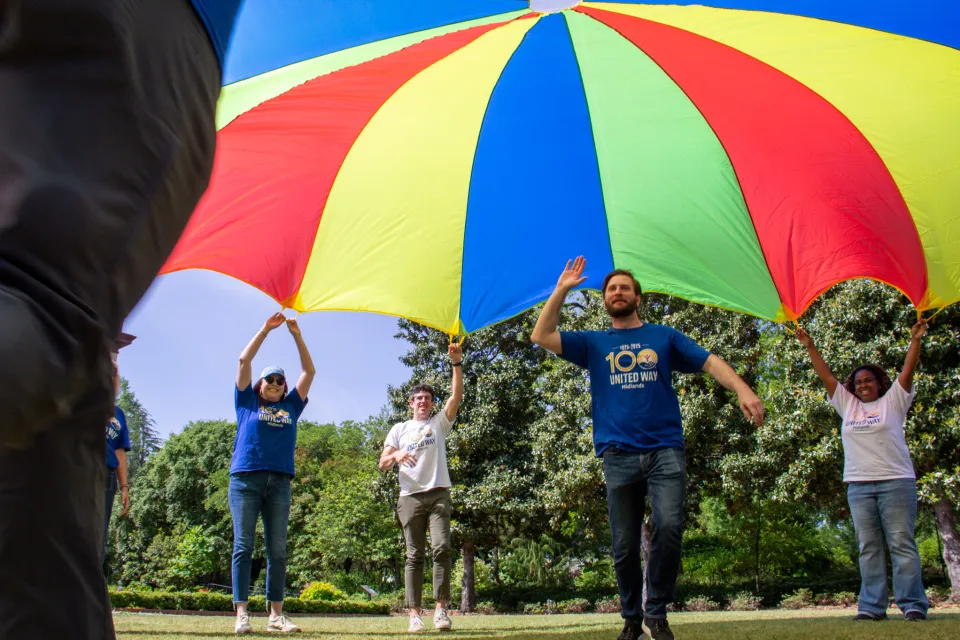 United Way staff having fun under a rainbow tent